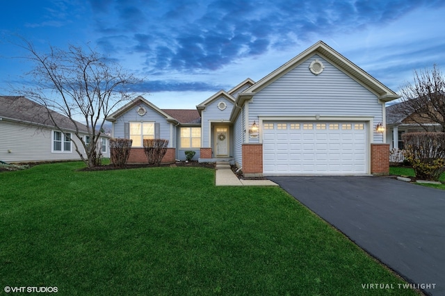 view of front of home featuring a lawn and a garage