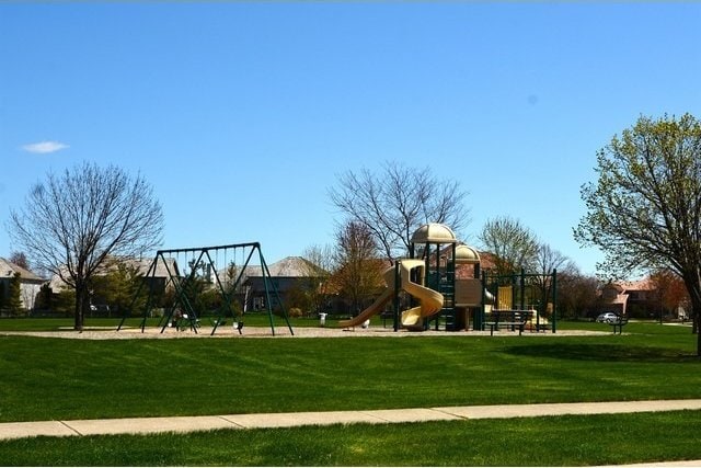 view of playground with a lawn