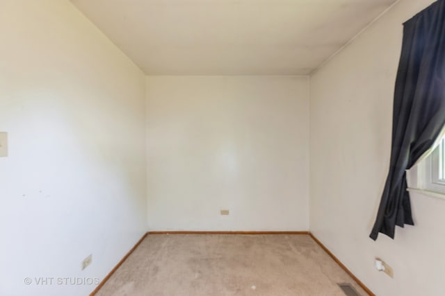 unfurnished room featuring light carpet