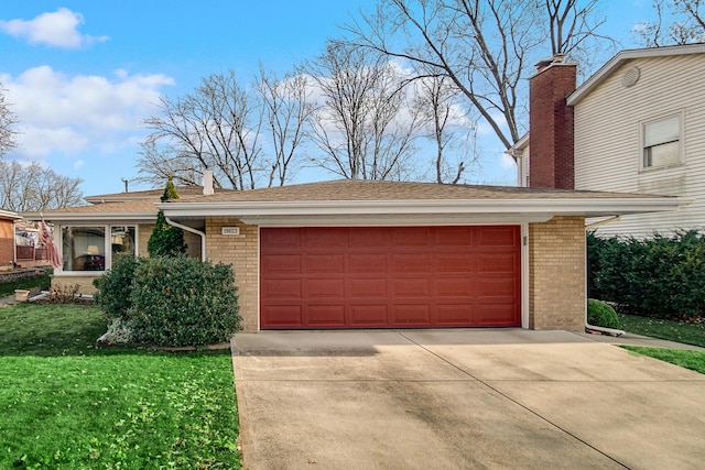 view of front of property with a garage and a front lawn