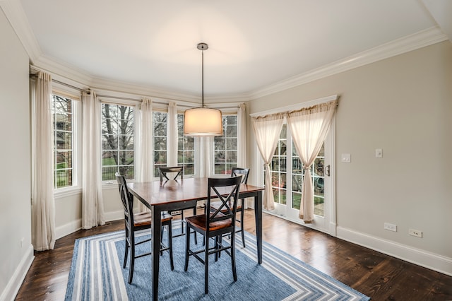 dining space with dark hardwood / wood-style flooring and crown molding