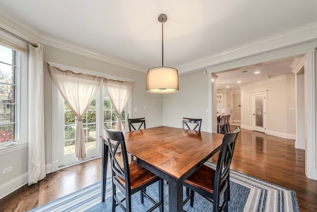 dining space featuring crown molding, plenty of natural light, and dark hardwood / wood-style floors