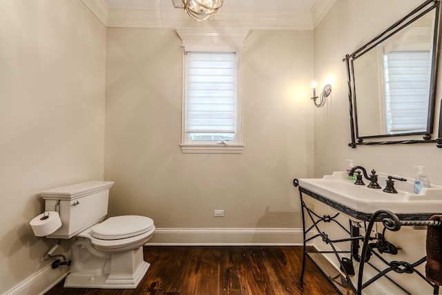 bathroom featuring crown molding, hardwood / wood-style floors, and toilet