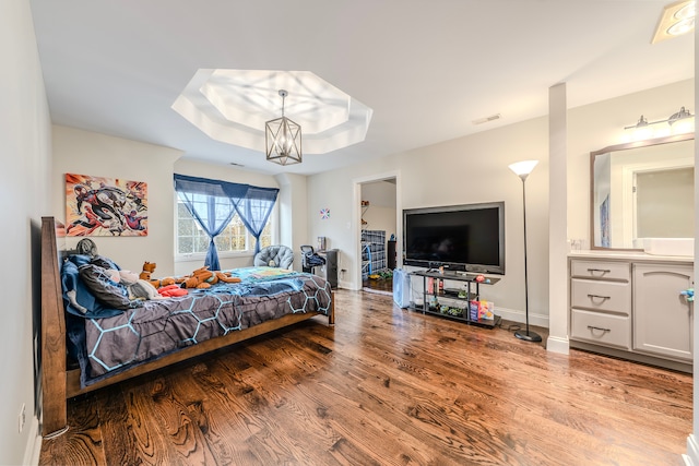 bedroom featuring a chandelier and light hardwood / wood-style floors