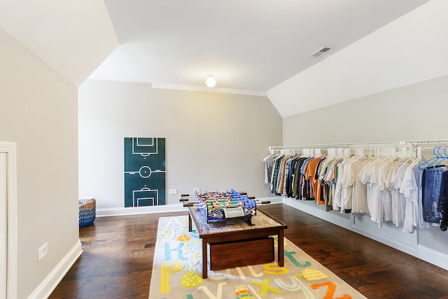 walk in closet with dark hardwood / wood-style flooring and lofted ceiling