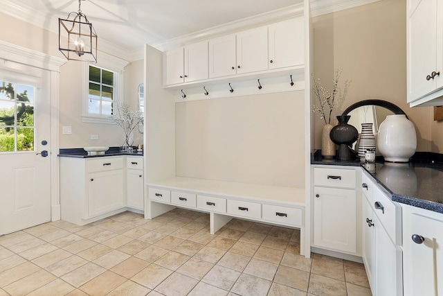 mudroom featuring crown molding, light tile patterned flooring, and a chandelier