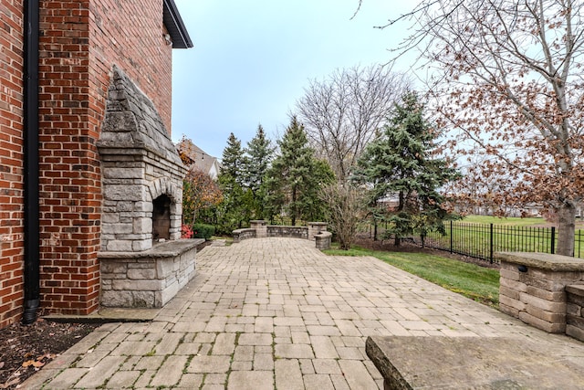 view of patio with an outdoor stone fireplace