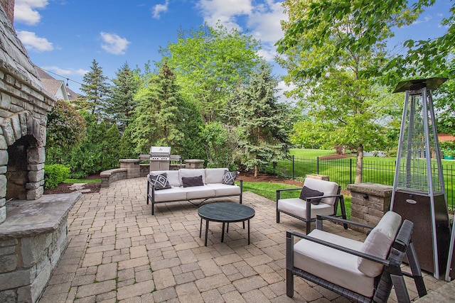 view of patio / terrace with area for grilling, an outdoor living space, and exterior kitchen