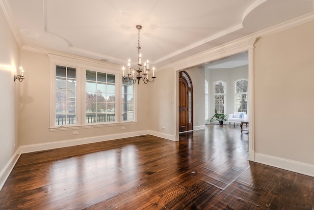 unfurnished dining area with a chandelier, ornamental molding, and dark wood-type flooring