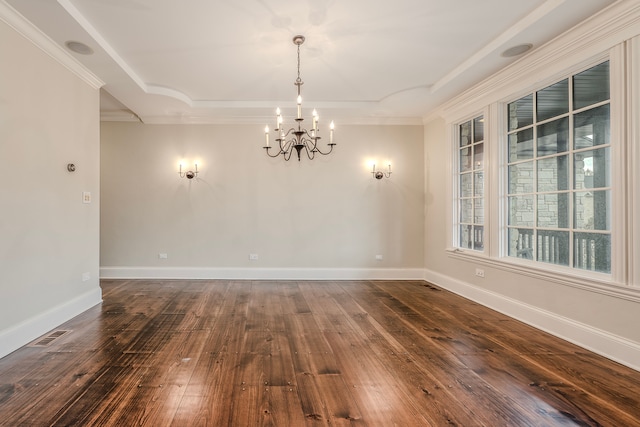 empty room featuring dark hardwood / wood-style flooring, crown molding, and a notable chandelier