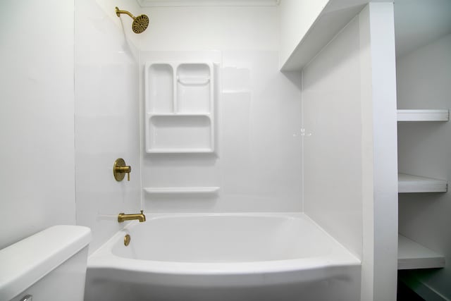 bathroom featuring shower / bathing tub combination and toilet