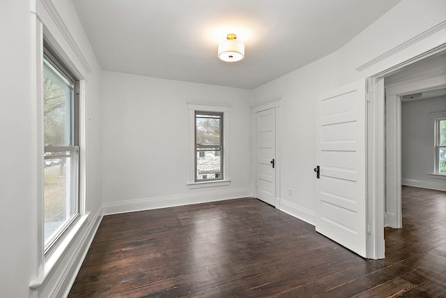 spare room with dark wood-type flooring