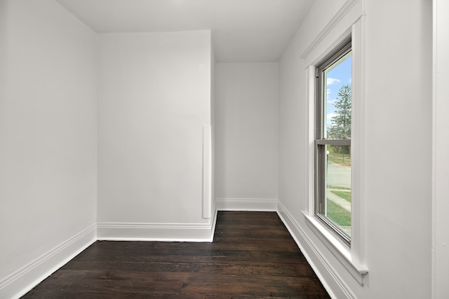 empty room with dark wood-type flooring