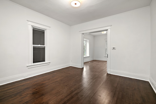 unfurnished room with dark hardwood / wood-style flooring and crown molding