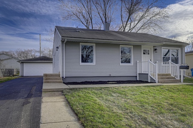 view of front of home with a garage, an outdoor structure, and a front lawn