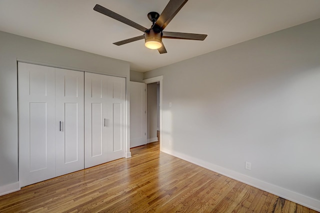 unfurnished bedroom with a closet, light hardwood / wood-style flooring, and ceiling fan