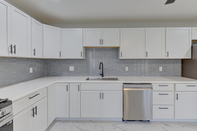 kitchen with stainless steel dishwasher, white cabinetry, and sink