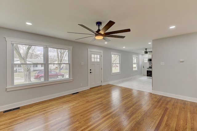 foyer entrance featuring light wood-type flooring and ceiling fan