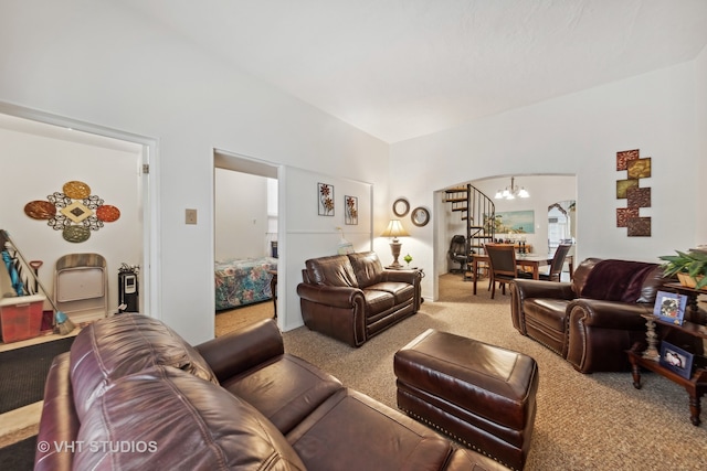 living room featuring a chandelier and carpet floors