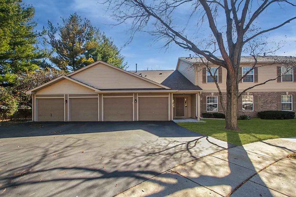 view of front of property with a front lawn and a garage