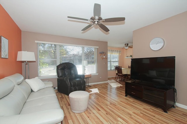 living room featuring light hardwood / wood-style flooring, plenty of natural light, and ceiling fan