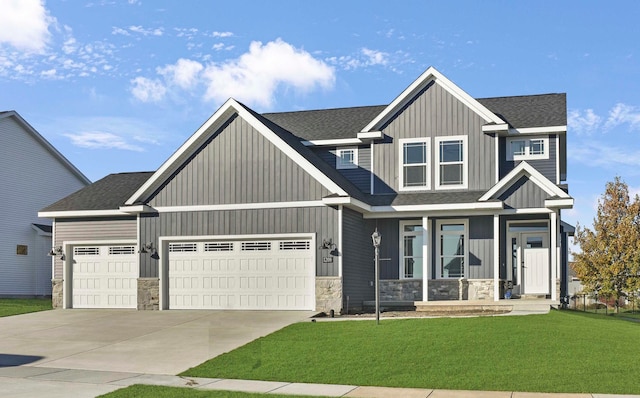 craftsman-style home featuring a garage and a front lawn