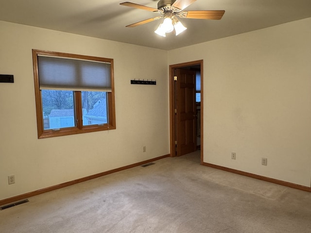 unfurnished room with ceiling fan and light colored carpet