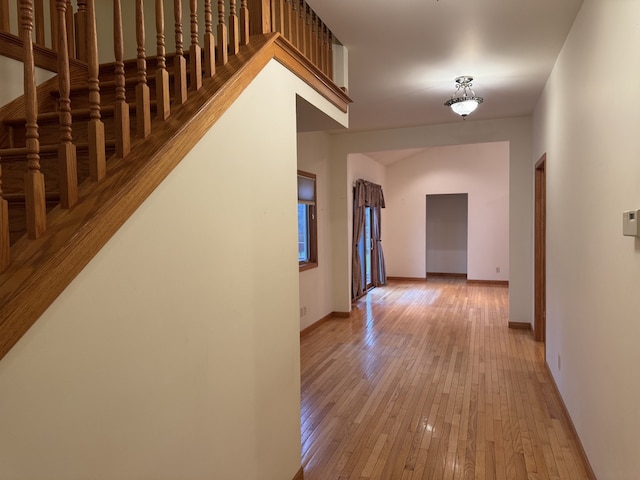 hallway with light hardwood / wood-style floors