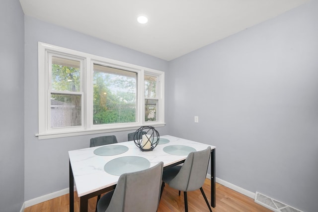 dining space featuring plenty of natural light and light hardwood / wood-style flooring