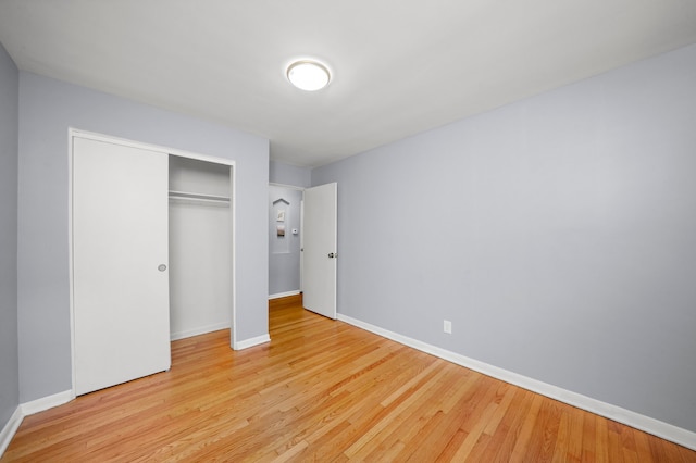 unfurnished bedroom with a closet and light hardwood / wood-style flooring