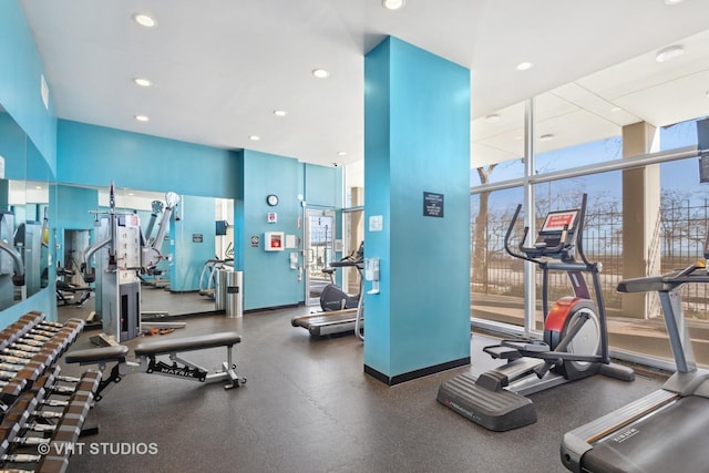 gym featuring recessed lighting, baseboards, and floor to ceiling windows