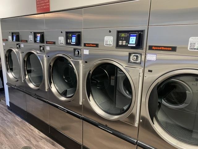 shared laundry area with wood finished floors and separate washer and dryer