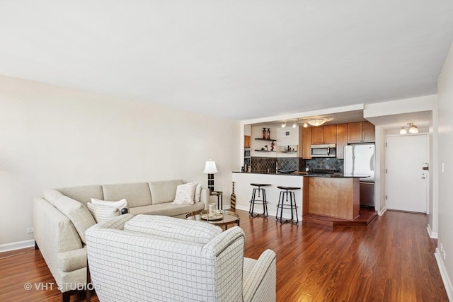 living area featuring dark wood finished floors and baseboards