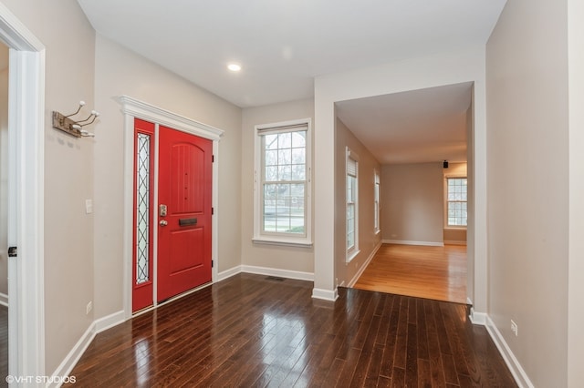 entrance foyer featuring plenty of natural light and dark hardwood / wood-style floors