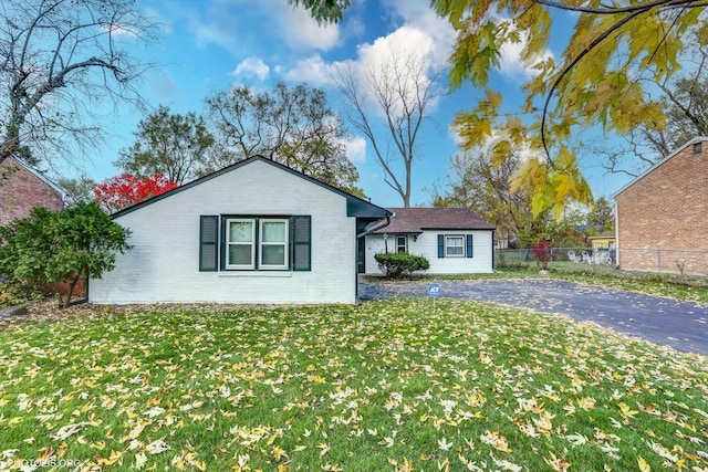 ranch-style home with a front lawn