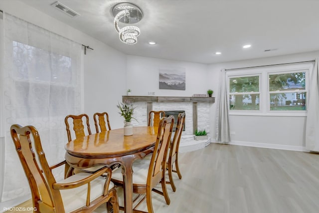 dining space with a chandelier and light wood-type flooring