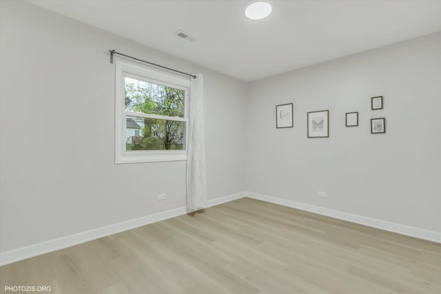 unfurnished room with light wood-type flooring