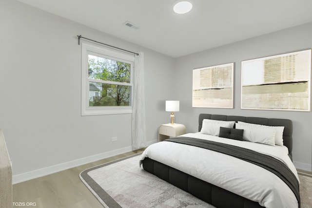 bedroom with hardwood / wood-style flooring