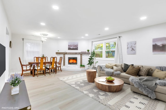 living room with a fireplace and light hardwood / wood-style flooring