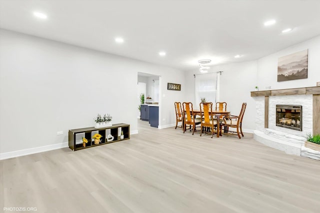 dining area with a fireplace and light wood-type flooring