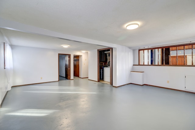 empty room with washer / clothes dryer and a textured ceiling