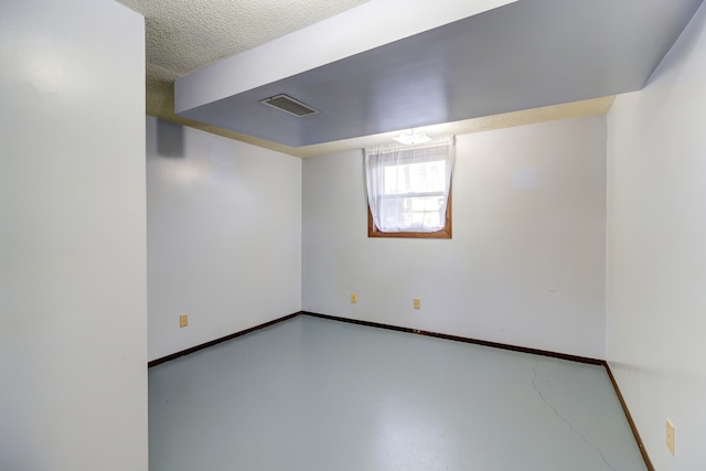 basement featuring a textured ceiling