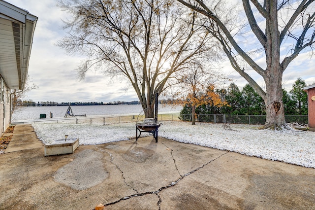 view of patio featuring a water view and an outdoor fire pit