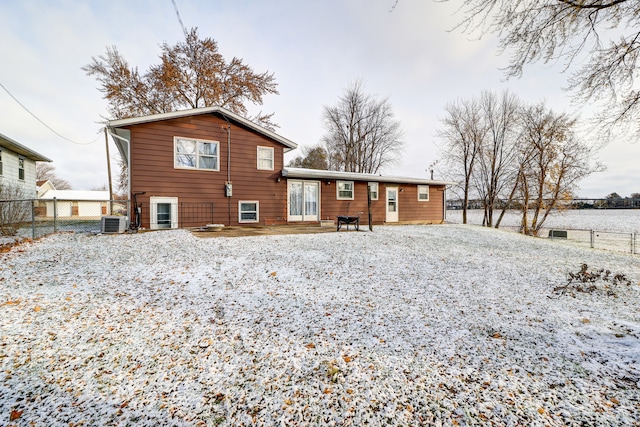 snow covered house with central AC