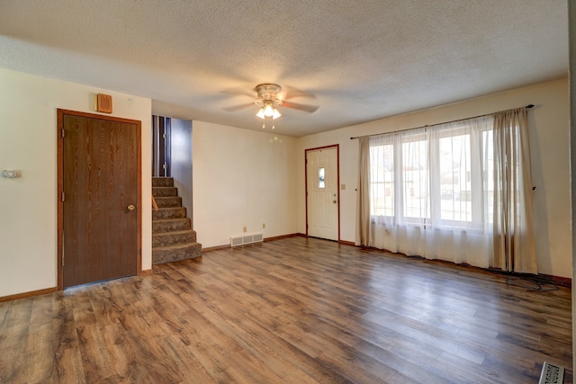 unfurnished room featuring hardwood / wood-style floors, a textured ceiling, and ceiling fan