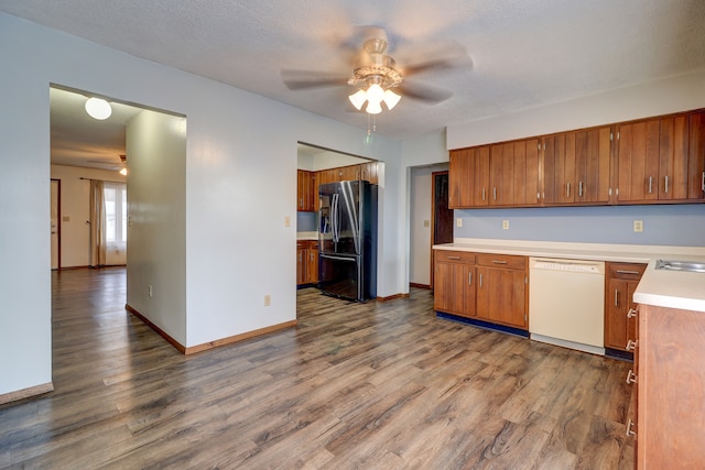 kitchen with stainless steel refrigerator with ice dispenser, white dishwasher, ceiling fan, and hardwood / wood-style floors