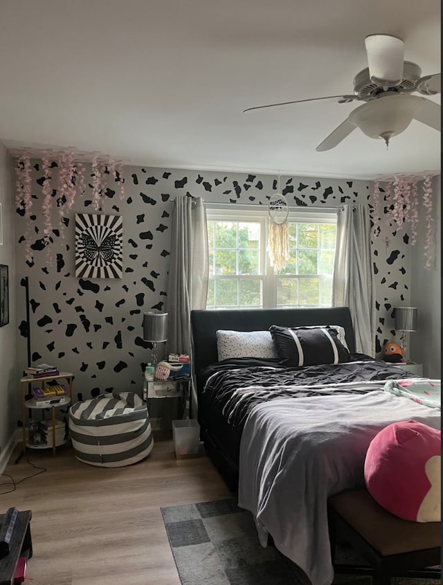 bedroom with hardwood / wood-style floors and ceiling fan