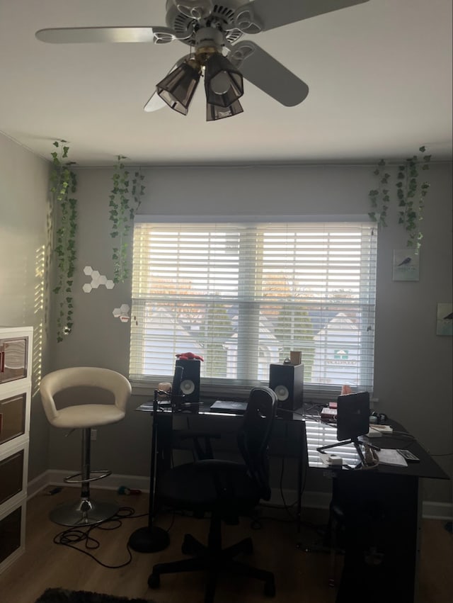 office with wood-type flooring and ceiling fan