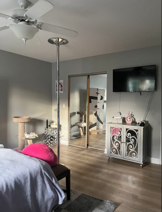 bedroom with hardwood / wood-style floors, ceiling fan, and a closet