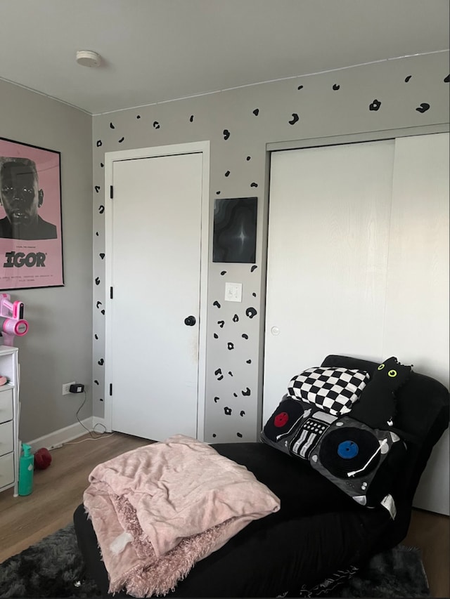 bedroom with hardwood / wood-style flooring and a closet